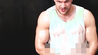 Muscular oiled stud jerks his hard cock solo