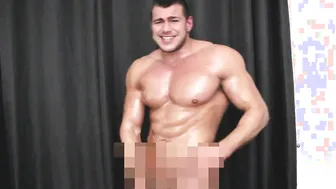 Oiled muscle hunk strokes his hard cock in solo handjob