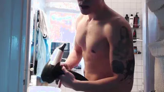 Young twink strokes his big cock and smokes in the shower